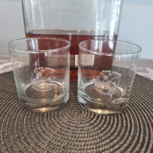 A glass of wine and two glasses on the table
