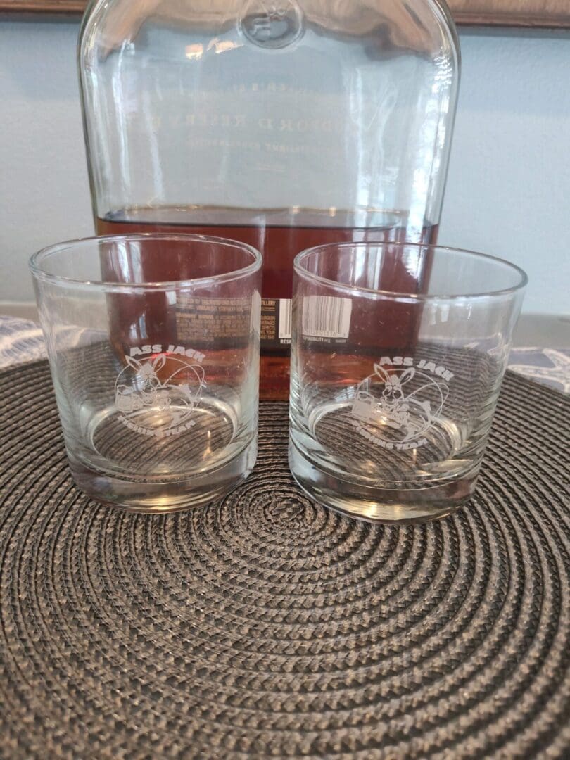 A glass of wine and two glasses on the table