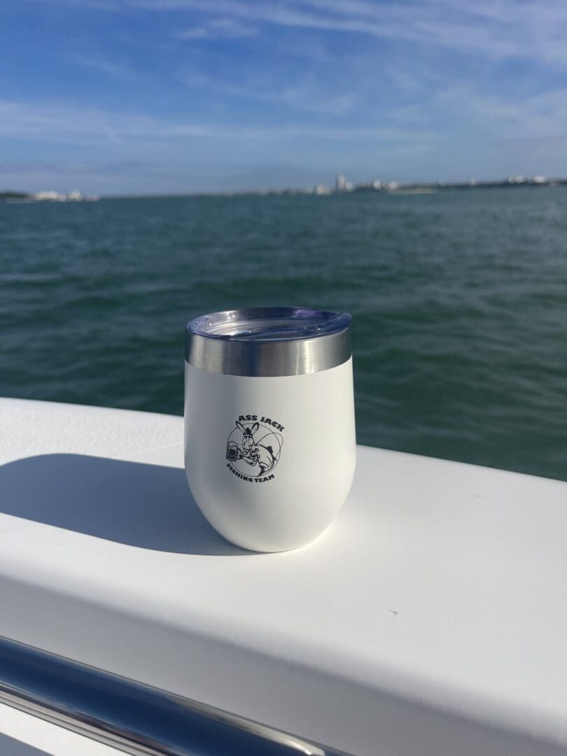 A cup that is sitting on the side of a boat.