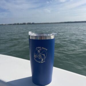 A blue cup sitting on top of a boat.