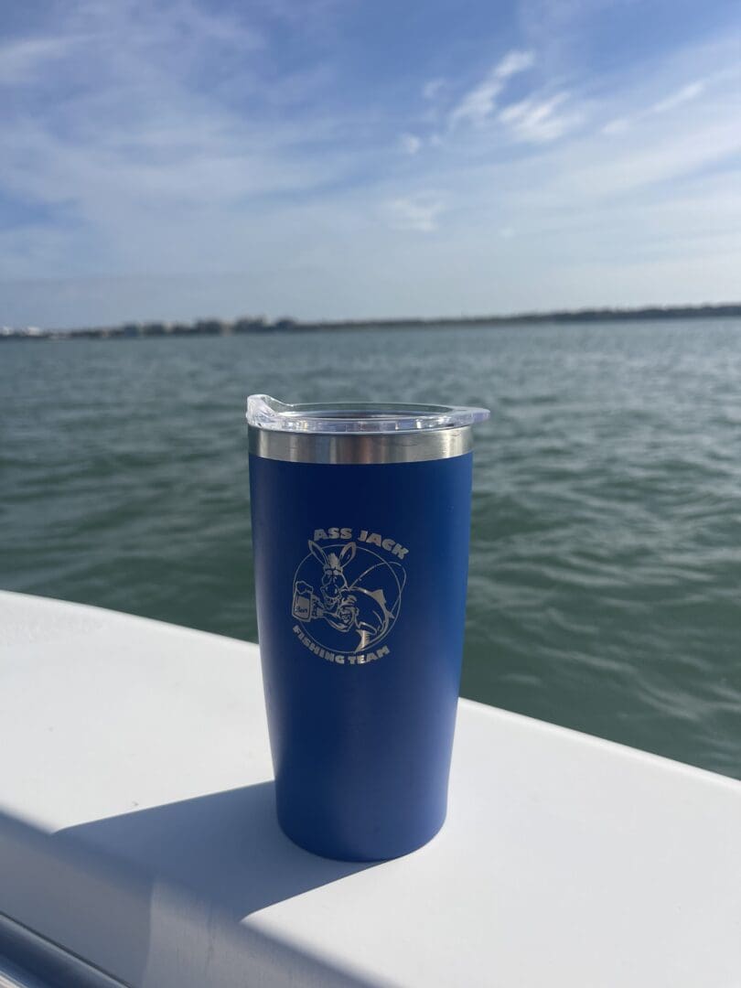 A blue cup sitting on top of a boat.